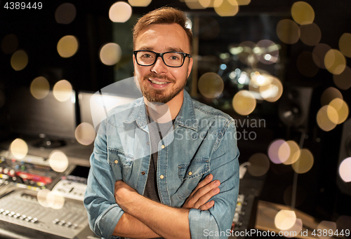 Image of man at mixing console in music recording studio