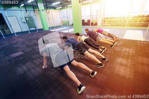 Image of group of people exercising in gym