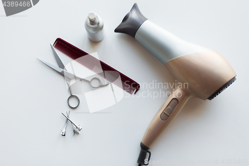 Image of hairdryer, scissors, comb and styling hair spray