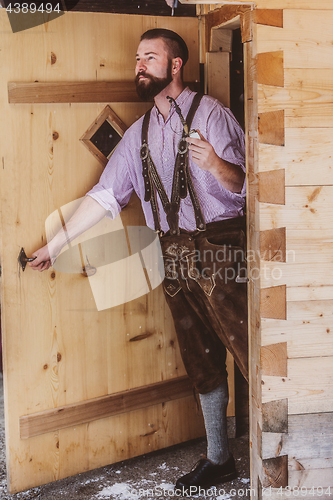 Image of Bavarian man with an old pipe in his hand