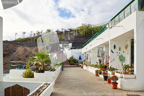 Image of cottages of Puerto del Carmen town on the coast of Atlantic Ocea