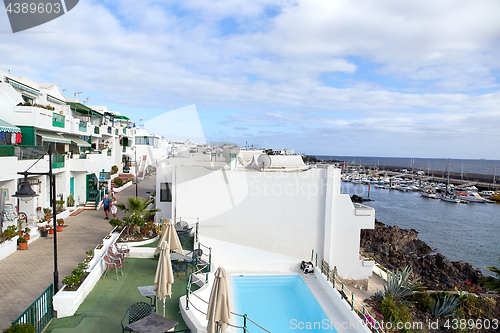 Image of cottages of Puerto del Carmen town on the coast of Atlantic Ocea