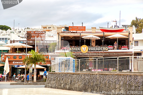 Image of Tourists are sitting and eating in restaurants of the Puerto del