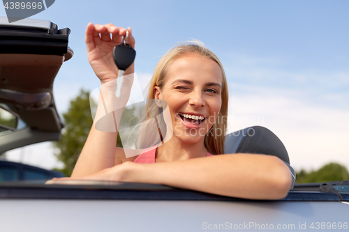 Image of happy young woman with convertible car key