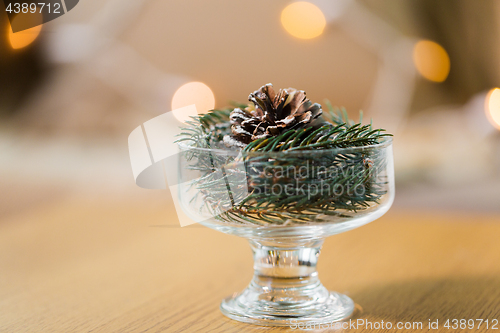 Image of christmas fir decoration with cone in dessert bowl