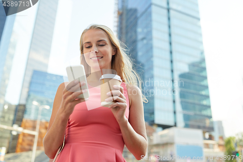 Image of woman with coffee and smartphone in city