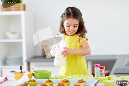 Image of little girl baking muffins at home