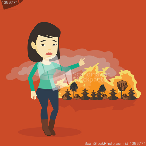 Image of Woman standing on the background of wildfire.