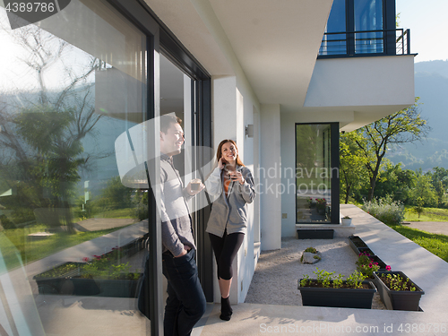 Image of couple enjoying on the door of their luxury home villa