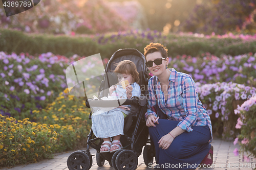 Image of mother and daughter in flower garden