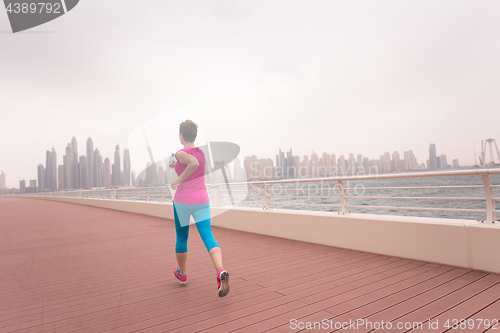 Image of woman running on the promenade