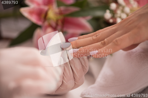 Image of Woman hands receiving a manicure