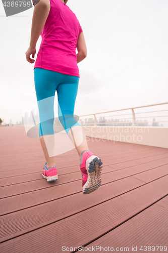 Image of woman running on the promenade