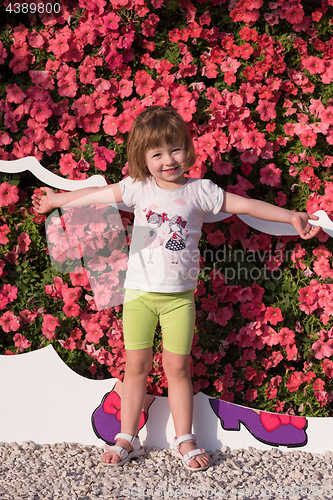 Image of little cute girl in a flower garden
