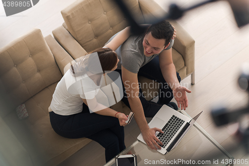 Image of happy young couple buying online