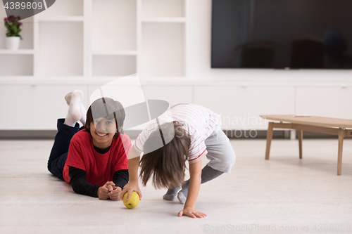 Image of boys having fun with an apple on the floor