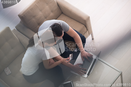 Image of happy young couple buying online