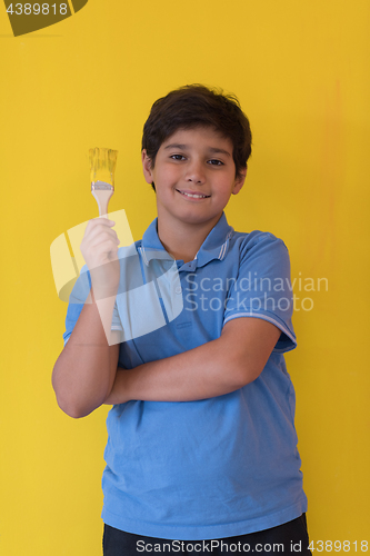 Image of Portrait of a happy young boy painter