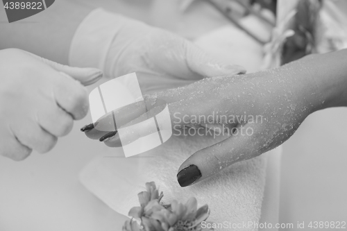 Image of Woman hands receiving a manicure