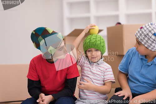 Image of boys with cardboard boxes around them