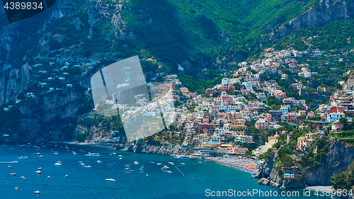 Image of One of the best resorts of Italy with old colorful villas on the steep slope, nice beach, numerous yachts and boats in harbor and medieval towers along the coast, Positano.