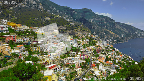 Image of One of the best resorts of Italy with old colorful villas on the steep slope, nice beach, numerous yachts and boats in harbor and medieval towers along the coast, Positano.