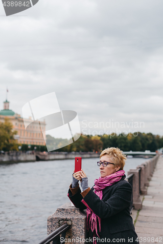 Image of Woman taking shots on waterfront