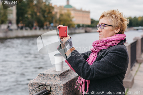 Image of Woman taking shots on waterfront