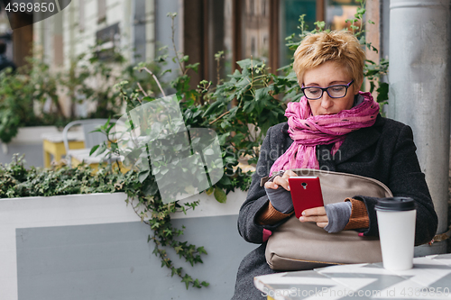 Image of Adult woman surfing phone