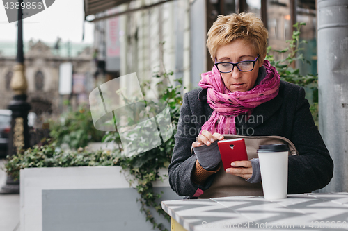 Image of Adult woman surfing phone