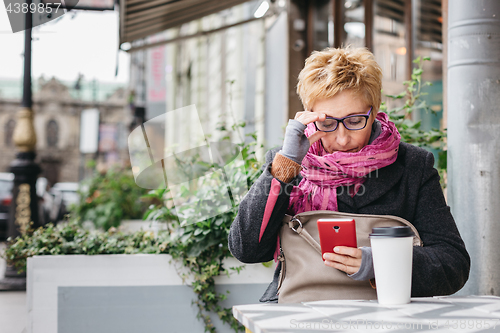 Image of Adult woman surfing phone