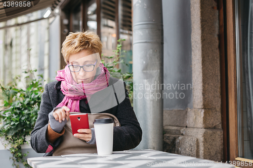 Image of Adult woman surfing phone