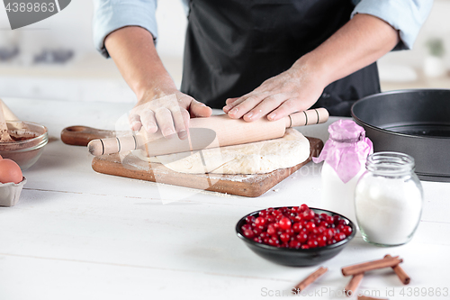 Image of A cook with eggs on a rustic kitchen against the background of men\'s hands