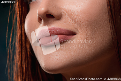 Image of Beautiful woman face portrait close up on dark