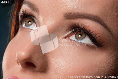 Image of Beautiful woman face portrait close up on dark