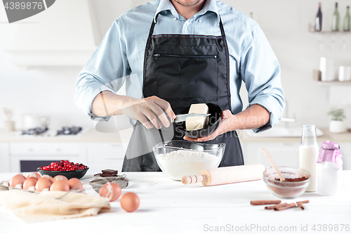 Image of A cook with eggs on a rustic kitchen against the background of men\'s hands