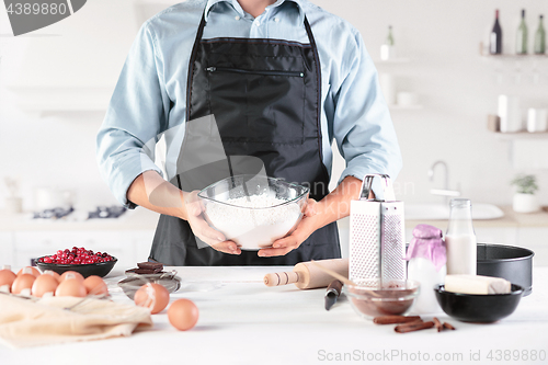 Image of A cook with eggs on a rustic kitchen against the background of men\'s hands