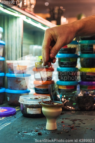 Image of Shisha hookah preparing by barman.