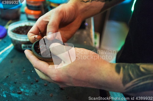 Image of Shisha hookah preparing by barman.