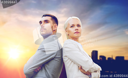 Image of businessman and businesswoman outdoors