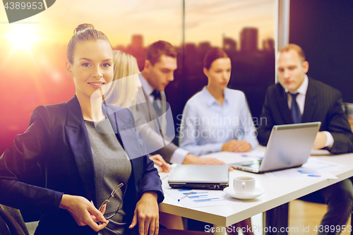 Image of businesswoman and business team at office