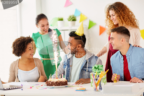 Image of office team greeting colleague at birthday party