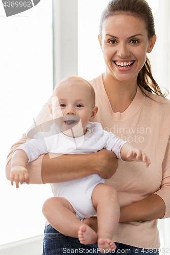 Image of happy mother with little baby boy at home