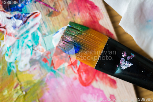 Image of close up of color palette and brush with paint