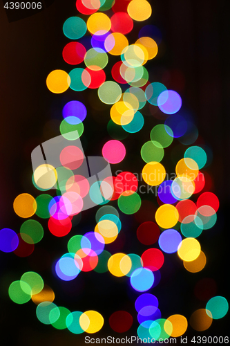 Image of  Unfocused Christmas tree with colorful lights 
