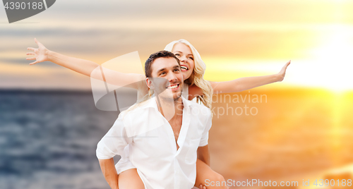 Image of happy couple over sea background