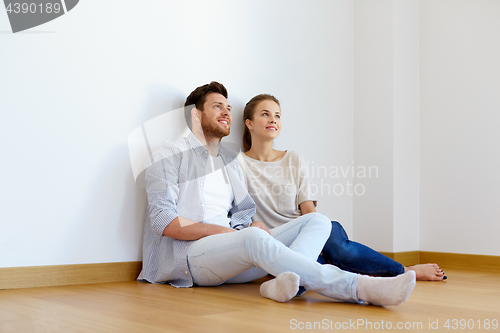 Image of happy couple at empty room of new home