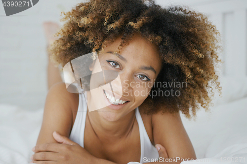 Image of Wonderful young woman posing on bed