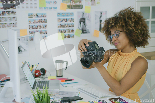 Image of Stylish photographer at creative workplace