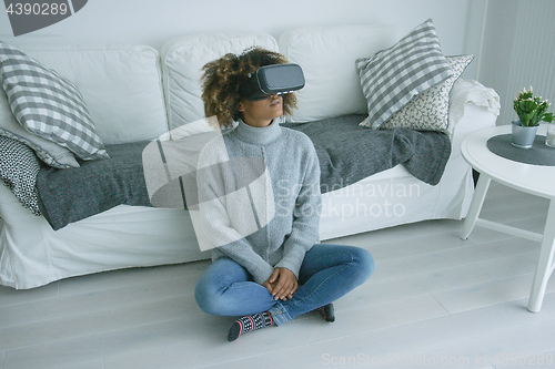 Image of Woman in VR glasses at home